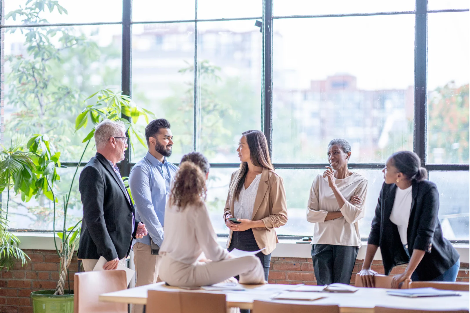 Professionals meeting in front of window